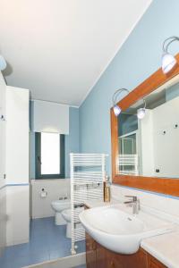 a bathroom with a sink and a toilet and a mirror at Villa Marta Luxury Sea View and Spa in Taormina +91 photos