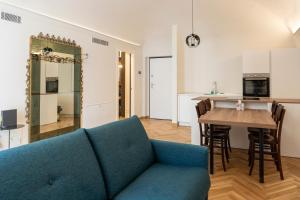 a living room with a blue couch and a table at Casa del viaggiatore in Turin