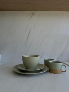 a table with two cups and a plate with a coffee mug at Crossroads Cabin in Sălişte +36 photos