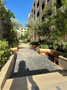 a shadow of a person on a street with benches at hurghada in Hurghada +11 photos