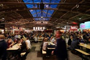 a large crowd of people sitting at tables in a restaurant at Ole Rømers Gade 108 in Aarhus