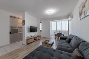 a living room with a couch and a table at Monaco Grand Apartments By CityBookings in Bucharest