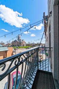 a balcony with a railing with a view of a street at Downtown Urban Loft above Restaurants #1 in Perryville