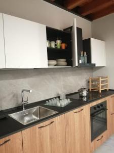a kitchen with a sink and a counter top at Palazzo Tof in Bocenago