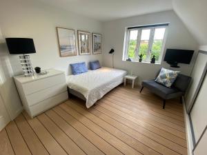 una camera da letto con un letto e una sedia di Private Rooms - Køge a Køge Altre 16 foto