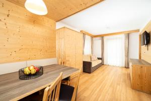 a kitchen and dining room with a table and a couch at Ciasa Sopl&agrave; in San Cassiano