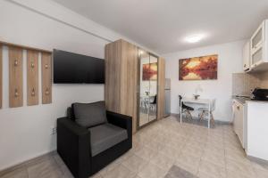 a living room with a chair and a table at Downtown Victoria Studios By CityBookings in Bucharest