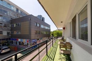 a balcony of a building with benches on it at Downtown Victoria Studios By CityBookings in Bucharest