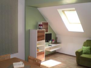 a living room with a skylight and a desk with a computer at Apartments Petar Pan in Krapinske Toplice