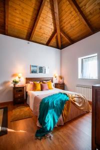 a bedroom with a large bed with a wooden ceiling at El Molino de Castiello de Jaca in Castiello de Jaca