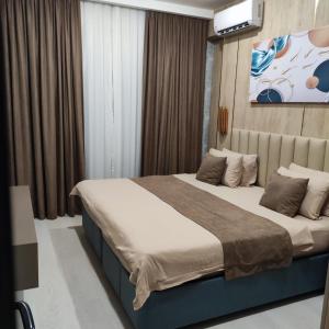 a bedroom with a large bed in a room at Badem Garden Apart Hotel in Tashkent