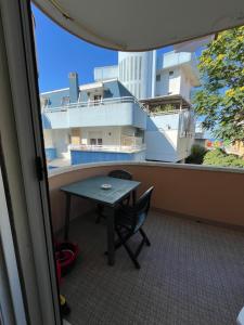a balcony with a table and a view of a building at Casa delle Onde Apartments in San Mauro a Mare