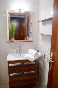a bathroom with a sink and a mirror at Fogar da Peixeira in Cambados