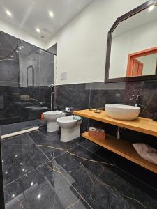 a bathroom with a sink and a toilet and a mirror at Lu Màri case vacanze in Balestrate +89 photos