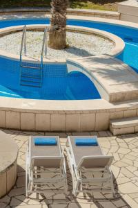 two lounge chairs and a swimming pool at Boutique Villa Filaus in Dubrovnik