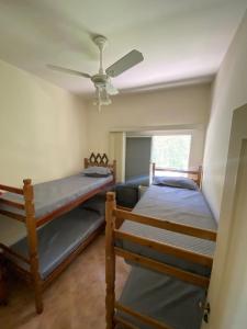 two bunk beds in a room with a ceiling fan at Casa de campo, com quadra de Beach Tennis, Volei e Fut Volei próxima a SP!! in Santana de Parnaíba +34 photos
