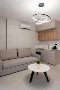 a living room with a couch and a table at Sealuxe Living in Iraklitsa