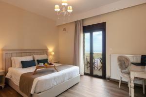 a bedroom with a bed with a table on it at Roupes Villa IV, Family villa, Fantastic views, Private pool in Roúpai +16 photos