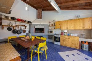 a kitchen with a wooden table and yellow chairs at Apartment Hubi in Klis