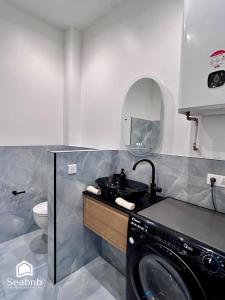 a bathroom with a sink and a washing machine at Seabnb - City & Sea - AC - 2 Min to Tram in Nice +29 photos