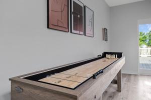 a wooden shuffleboard table in a living room at Lighthouse Lookout in Saint Joseph