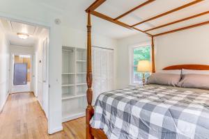 a bedroom with a canopy bed and a hallway at Alpharetta Home with Patio and Yard about 3 Mi to Downtown in Alpharetta