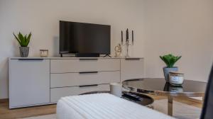 TV a/nebo společenská místnost v ubytování Flat Bull Appartement mit Garten