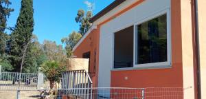 a house with a large window on the side of it at Sa domu nosta è un appartamento. in Castiadas