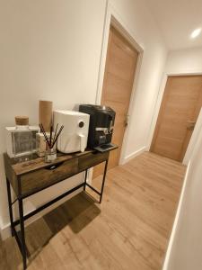 a room with a table with a coffee maker and a microwave at Heathrow luxury stay in Feltham +6 photos