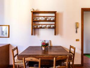 a dining room with a wooden table and chairs at Apartment Martina by Interhome in Gravedona