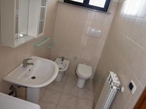 a bathroom with a sink and a toilet at Studio Adriatico-1 by Interhome in San Silvestro +4 photos