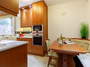 a kitchen with a wooden table and a counter top at Apartment Lily by Interhome in Balatonfüred