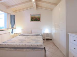 a bedroom with a bed and a painting on the wall at Villa Niccolò by Interhome in Forte dei Marmi
