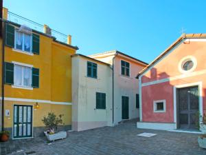 a row of colorful buildings in a courtyard at Holiday Home Casale by Interhome in Moneglia