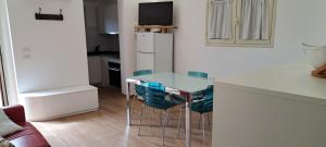 a kitchen with a table and chairs and a refrigerator at Casa Giulia in Castelbuono