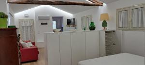 a living room with white cabinets and a tv at Casa Giulia in Castelbuono