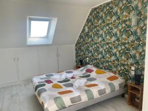 a bedroom with a bed with a patterned wall at Ker Breizh in Saint-Brieuc