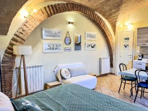 a bedroom with a bed and a chair in a room at Apartment Fattoria Palazzeta by Interhome in La Cinquantina