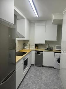 a white kitchen with white cabinets and appliances at Origen HARO paternina in Haro +7 photos