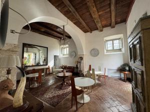 a living room with tables and chairs and a dining room at Villa Dell'Annunziata in Rieti