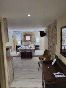 a bedroom with a bed and a tv in a room at LEMON TREE Square house in Corfu