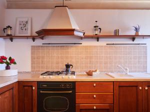 a kitchen with a stove and a sink at Holiday Home Oro del Lario by Interhome in Bellano