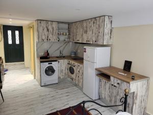 a kitchen with a refrigerator and a washer and dryer at LEMON TREE Square house in Corfu
