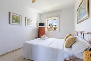 a white bedroom with a bed and a window at Home Olimpo Torre del Mar in Torre del Mar +28 photos