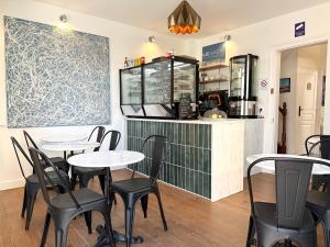 a restaurant with tables and chairs and a counter at Villa Jade Etretat in Étretat