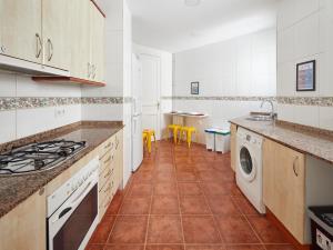 a kitchen with white cabinets and a tile floor at Gran Via - 1 in Barcelona