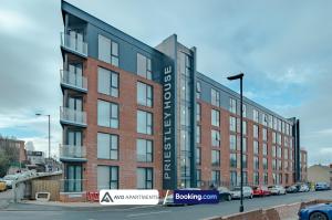 a brick building with a sign on the side of it at Prime Serviced Apartments Sheffield Center in Sheffield
