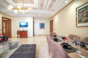 a dining room with a table and chairs at Luxury Seafront Apartment 101sqm with 2 Bedrooms and Wi-Fi Unlimited in Agadir