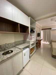a kitchen with a sink and a living room at Spazzio diRoma com acesso ao Acqua Park - Luciana in Caldas Novas +37 photos