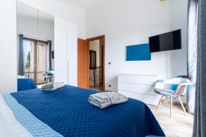 a bedroom with a blue bed and a chair at Deep Blue Sea in Arenella +44 photos